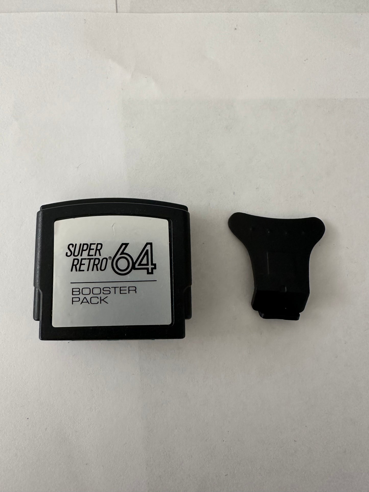 Jumper pak for the Nintendo 64 with removal tool.
